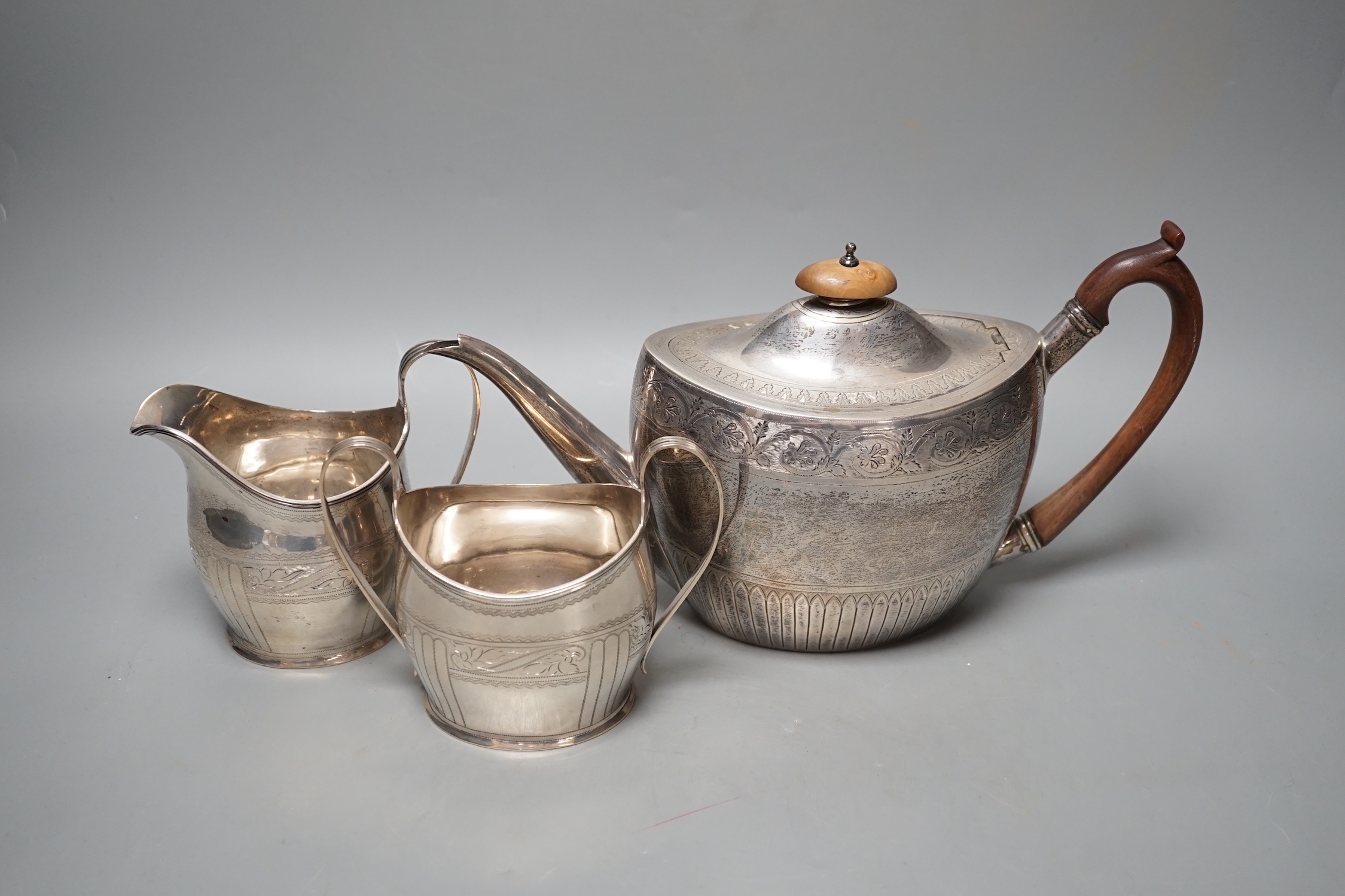 A 1930's engraved silver oval three piece tea set, S. Blanckensee & Sons Ltd, Chester, 1936/7, gross weight 26.5oz.